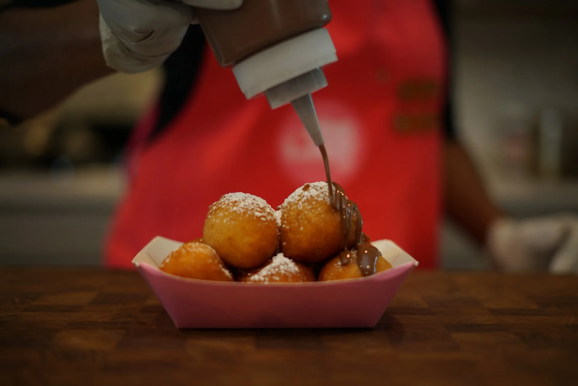 Puff Puffs being drizzled with chocolate